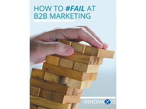 Innovaxis #Fail at B2B Marketing e-book cover, hand pushing over wooden blocks